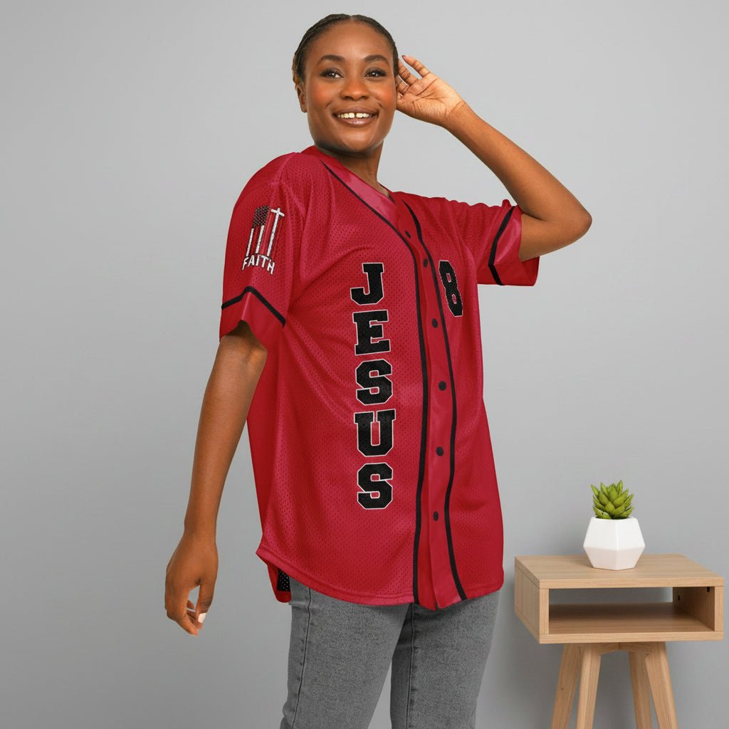 Person wearing a red baseball jersey with 'Jesus' printed on it, on a plain background