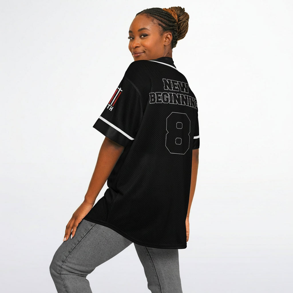Woman wearing a black jersey with 'New Beginnings' and number '8' on a white background
