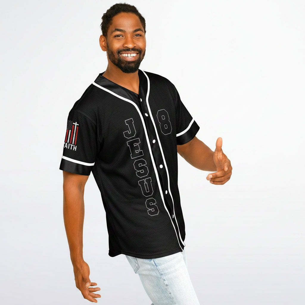 Man wearing a black baseball jersey with white accents on a plain background
